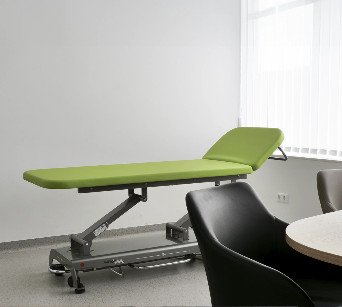 examination table with green padding in doctor's office