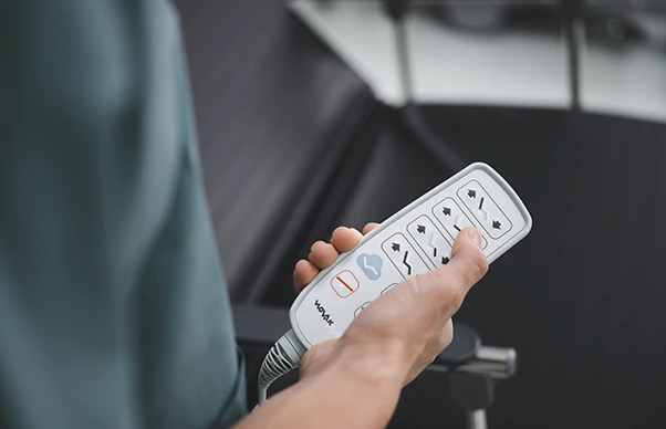male nurse holding a hand switch of a day hospital chair