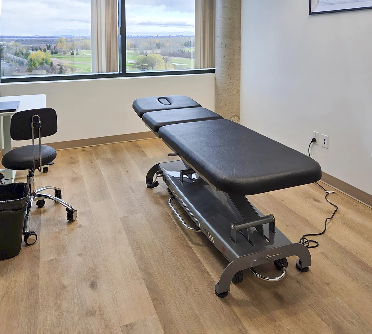 massage table with black padding in treatment room