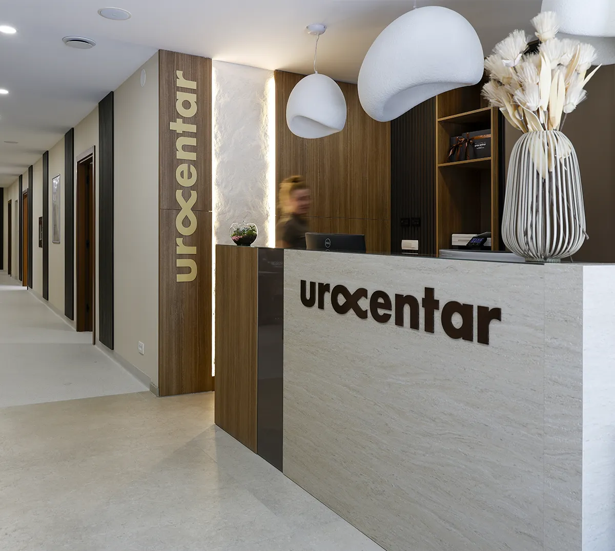 Reception desk and entrance area at Poliklinika Urocentar with modern interior design.